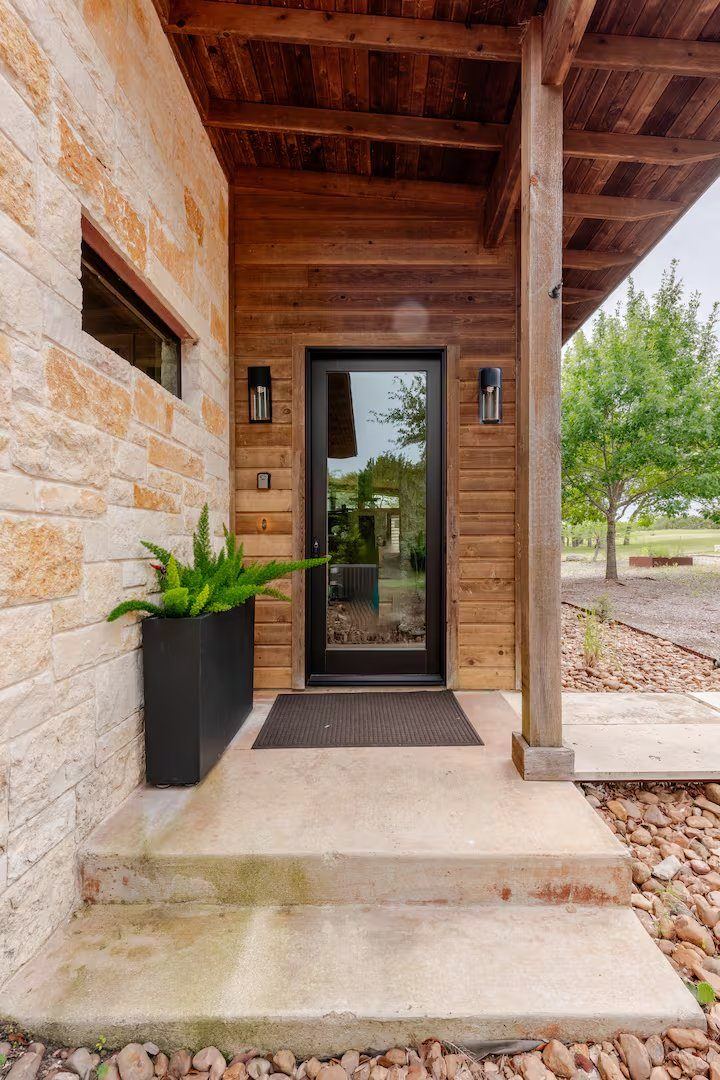 La Paz front entry — reclaimed wood and limestone walls under a covered porch