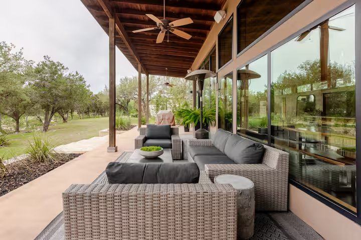 La Paz covered patio with sectional sofa, ceiling fan, and Hill Country views